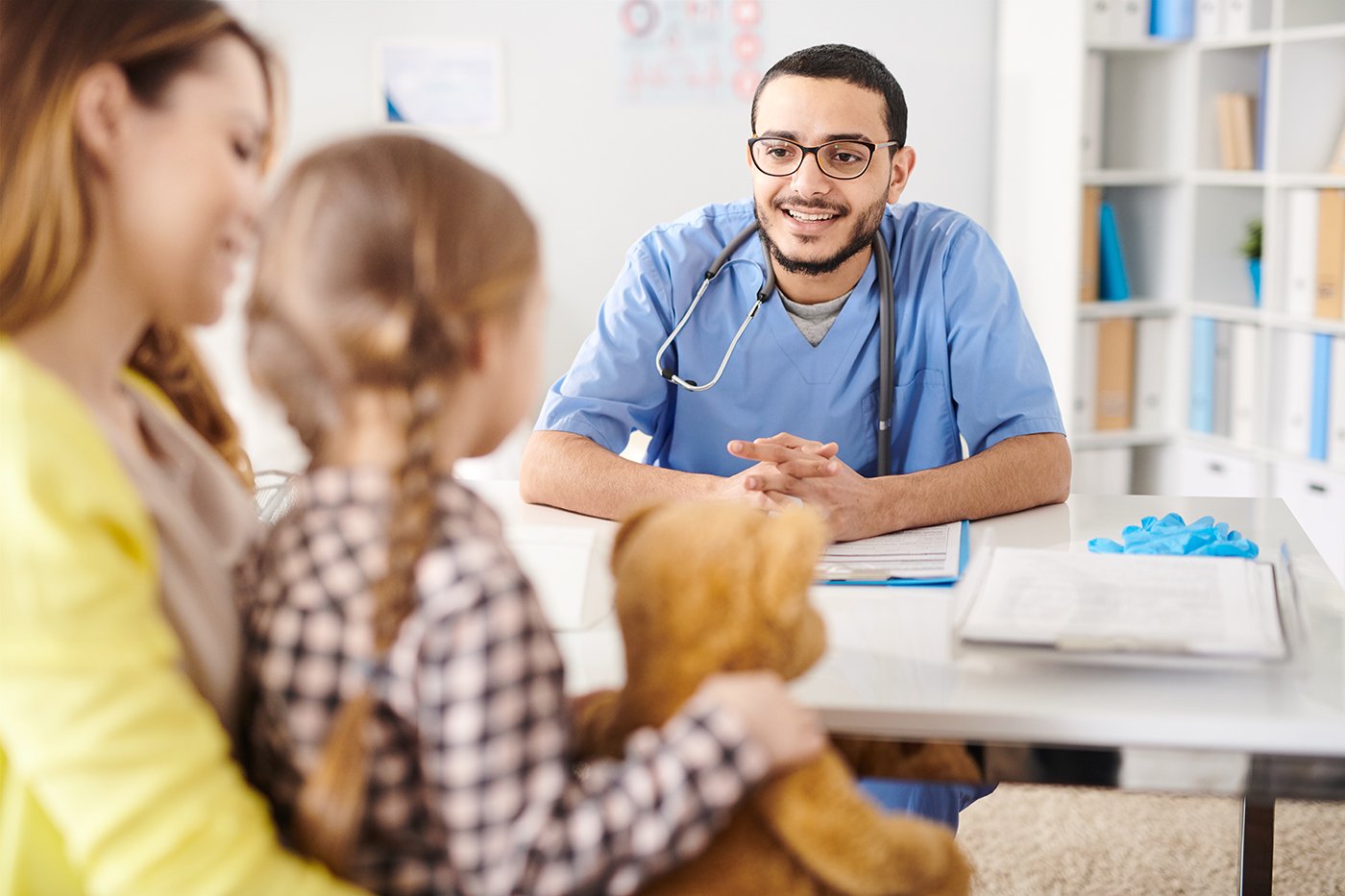 Pediatrician talking to parent and child